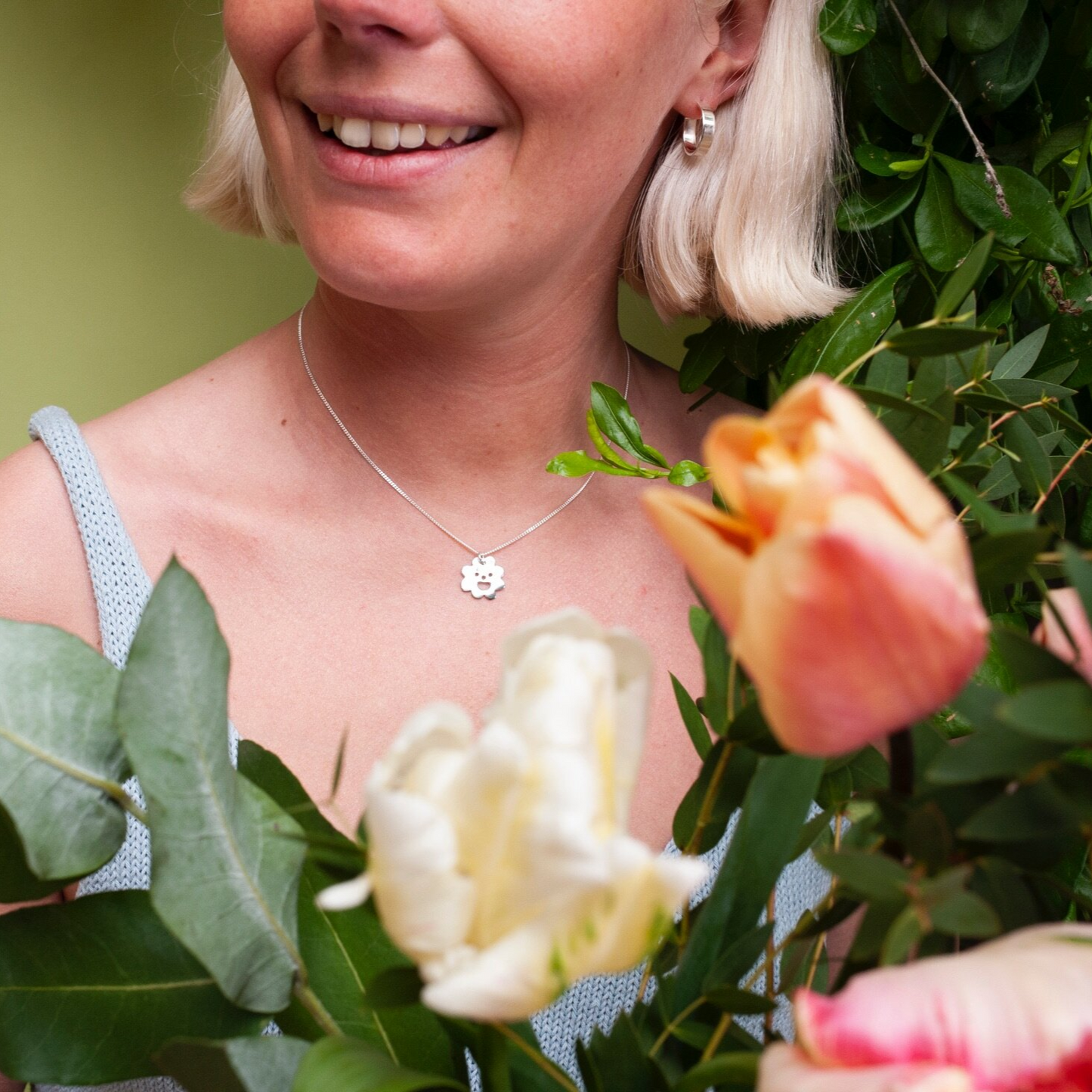 Woman wearing small, thick silver hoop earring