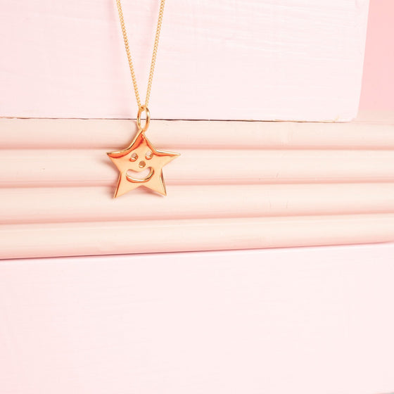 Close up of gold Smiley Star Necklace