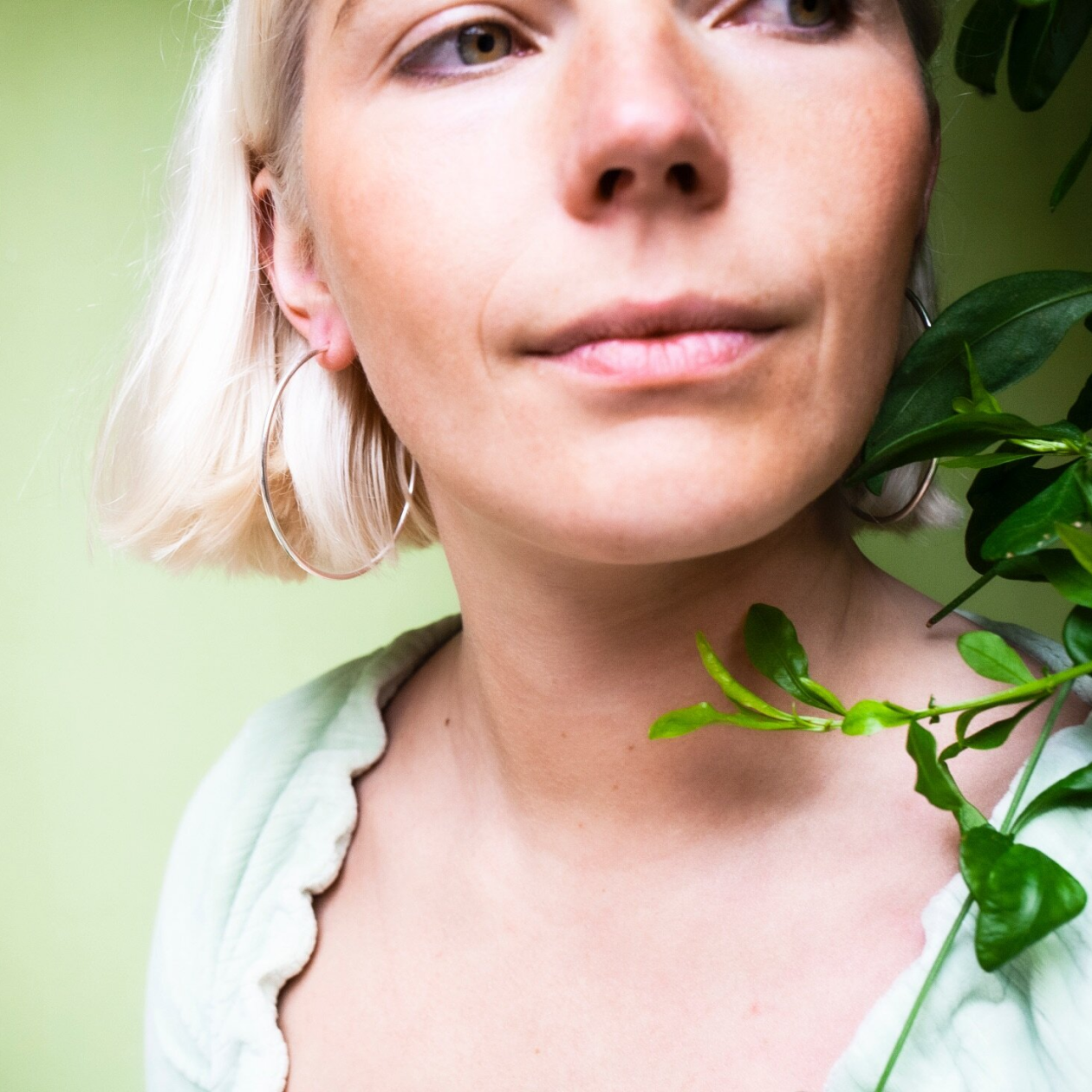 Woman wearing large silver hoop earrings