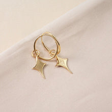  Small gold hoop earrings with a star shaped charm 