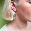 Close up of woman wearing silver Smiley Sun Hoops earring