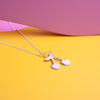 Close up of silver pendant necklace with a cherry shaped charm