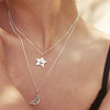 Close up of woman wearing Smiley Star Necklace