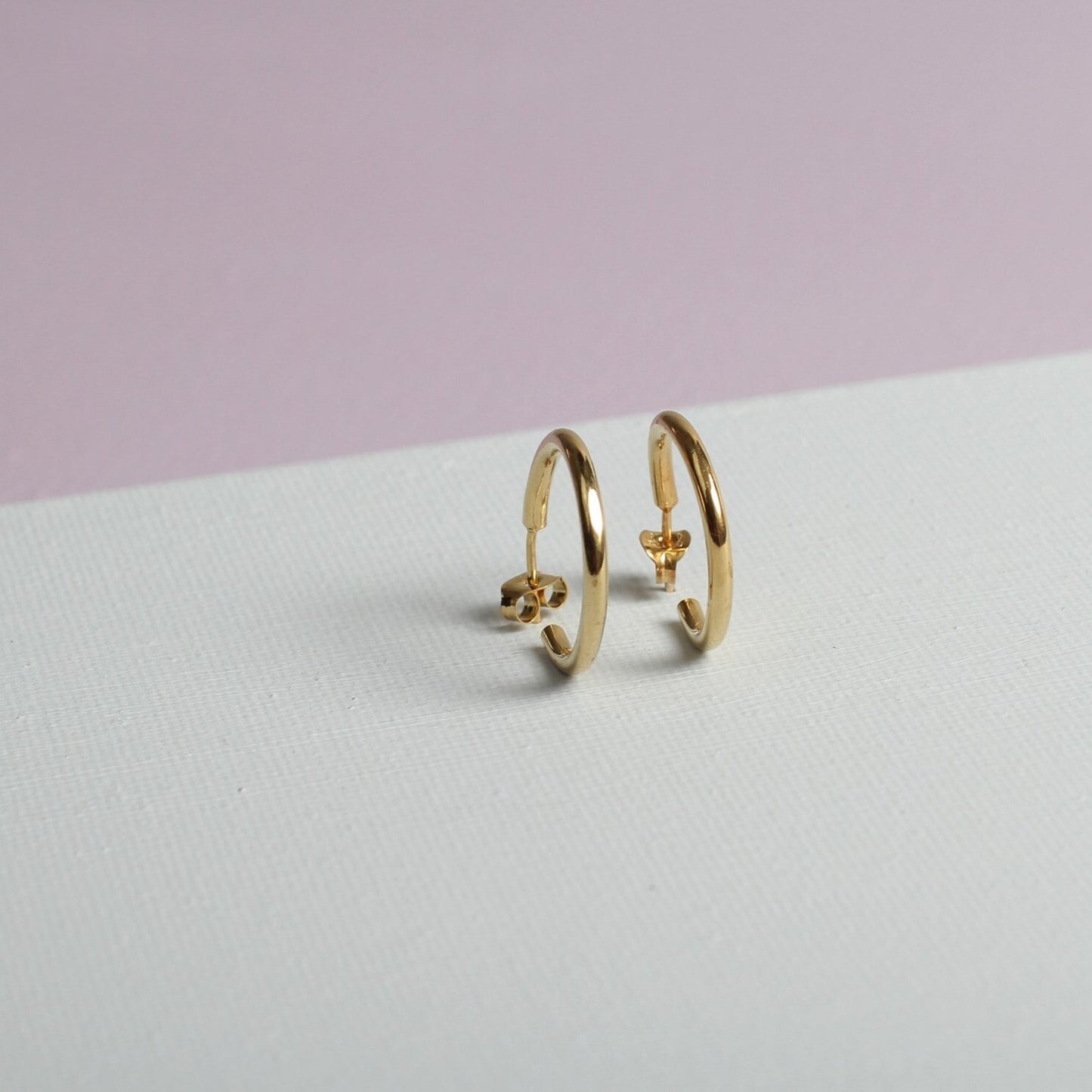 Close up of small gold hoop earrings