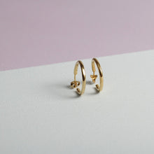  Close up of small gold hoop earrings