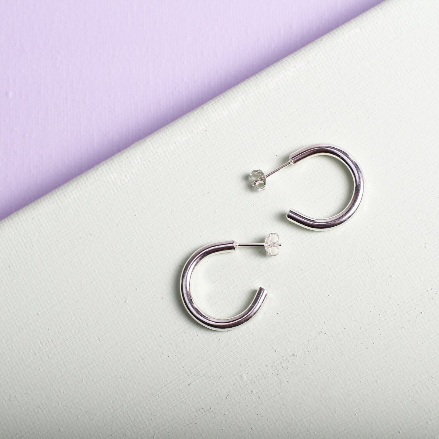 Close up of small silver hoop earrings