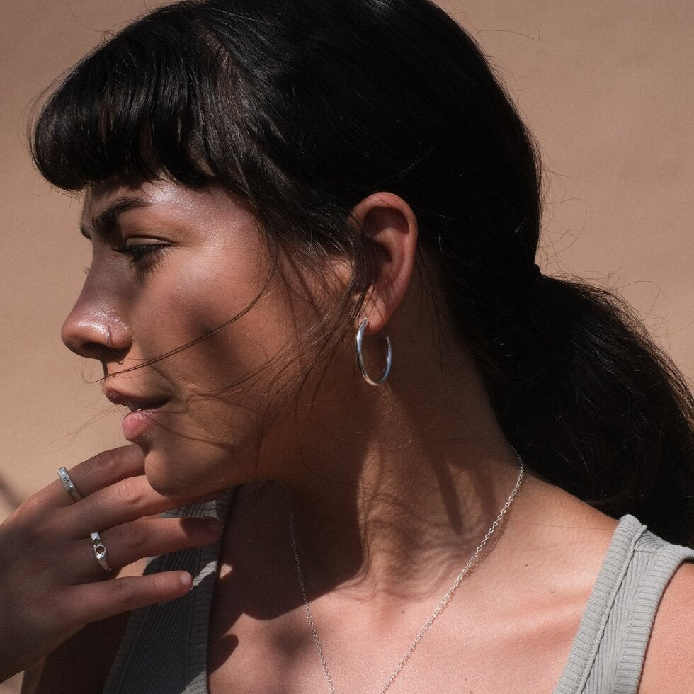 Woman wearing silver hoop earring