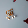 Gold hoop earrings with a cherry charm